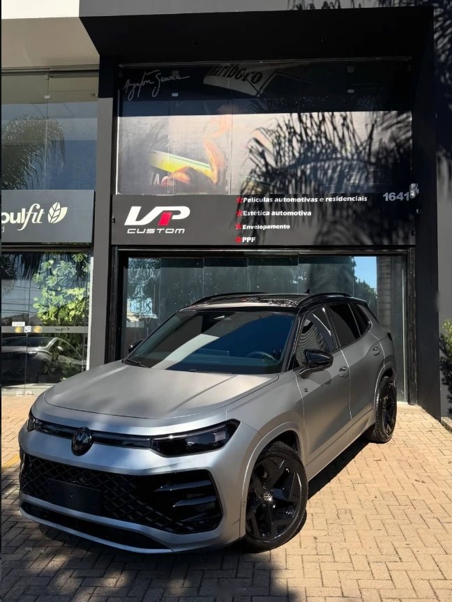 Fachada da VP Custom em Novo Hamburgo, com o letreiro da loja e uma Volkswagen Tiguan cinza fosco estacionada na frente